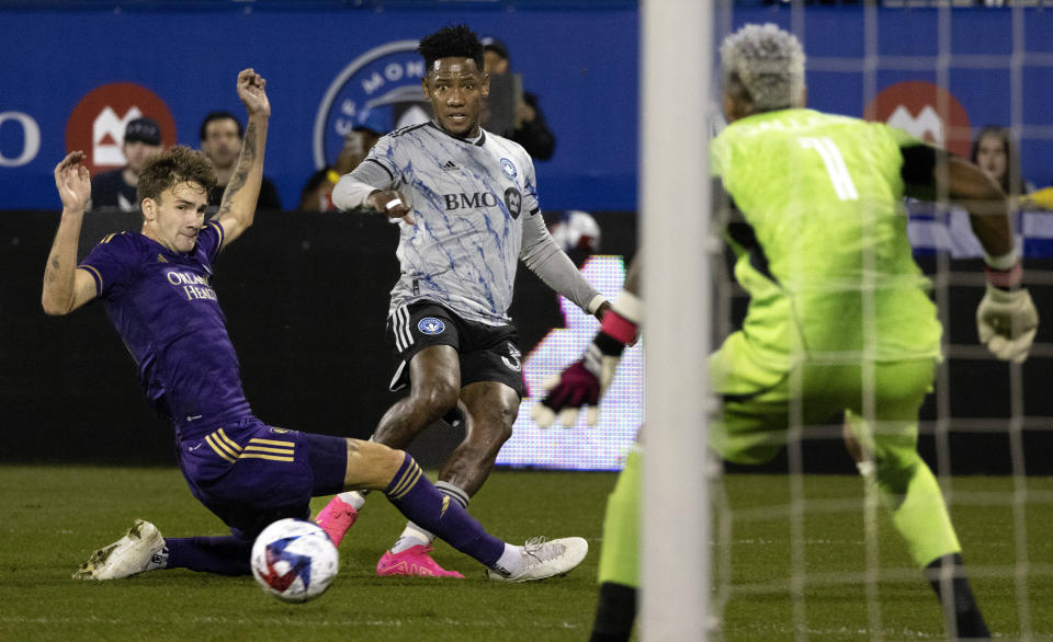 Orlando City defender Michael Halliday, left, and CF Montreal forward Romell Quioto watch as Quioto misses his shot on Orlando City goalkeeper Pedro Gallese during the second half of an MLS soccer game in Montreal, Saturday, May 6, 2023. (Allen McInnis/The Canadian Press via AP)