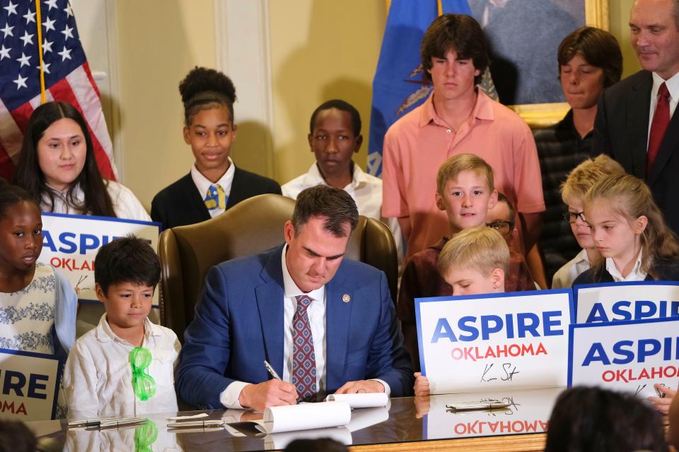 Oklahoma Gov. Kevin Stitt holds a signing ceremony for a school choice education bill on Thursday in the Blue Room at the Capitol.