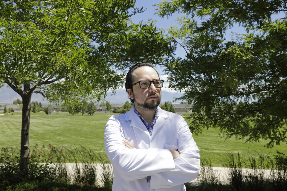 In this Thursday, June 11, 2020, photo, Edison Suasnavas, a cancer and coronavirus researcher, poses for a photograph near his home in Saratoga Springs, Utah. Suasnavas would not be able to analyze cancer cells for a living without the Deferred Action for Childhood Arrivals, or DACA, program. The U.S. Supreme Court has kept alive, for now, the Obama-era program that allows immigrants brought here as children to work and protects them from deportation. (AP Photo/Rick Bowmer)