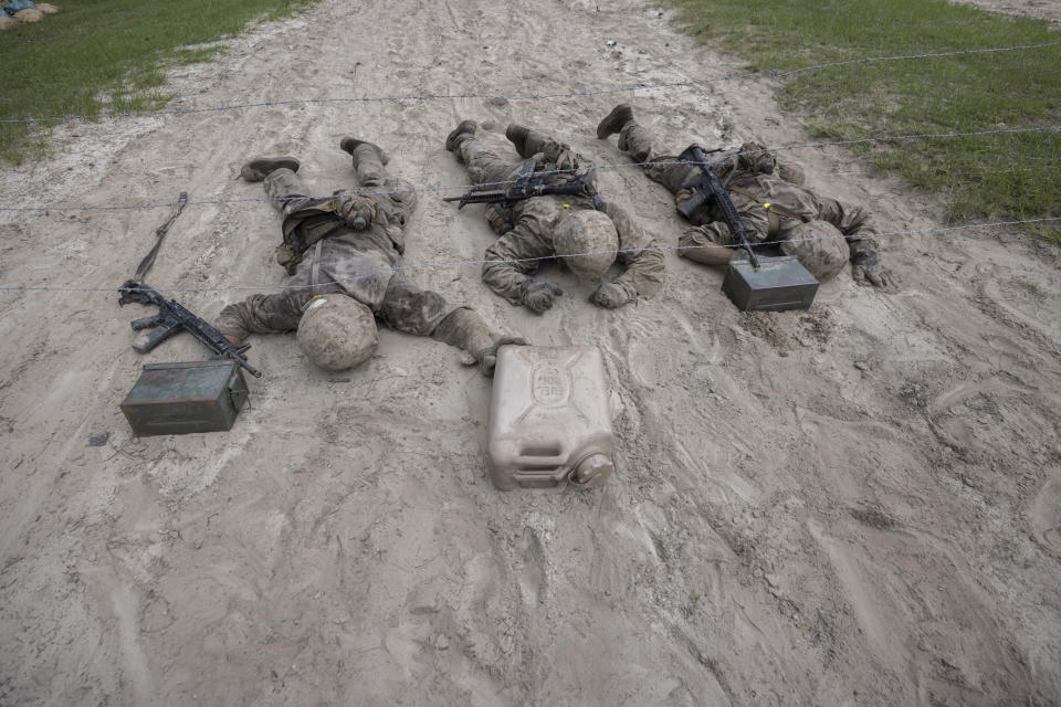 Three U.S. Marine Corps male recruits negotiate an obstacle during during a portion of training known as the Crucible at the Marine Corps Recruit Depot, Thursday, June 29, 2023, in Parris Island, S.C. (AP Photo/Stephen B. Morton)