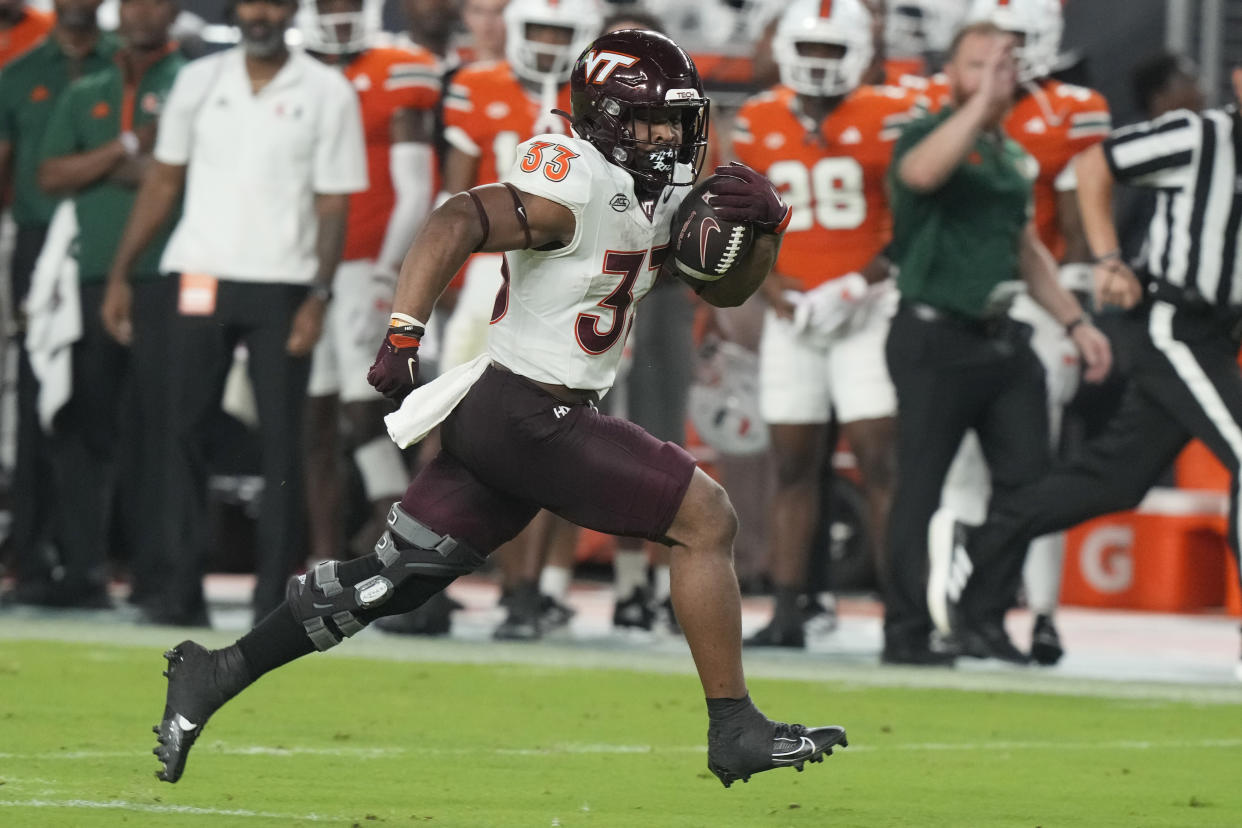 Virginia Tech running back Bhayshul Tuten (33) runs for a touchdown during the first half of an NCAA college football game against Miami, Friday, Sept. 27, 2024, in Miami Gardens, Fla. (AP Photo/Marta Lavandier)