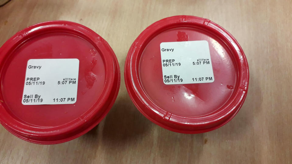 Picture of the gravy Karl Cooper received from the KFC, where staff wrote "s**tface" on the lid.