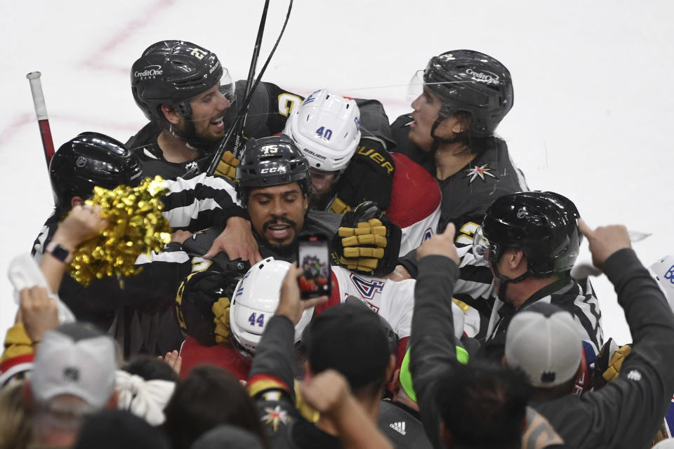 Players try separating Vegas Golden Knights right wing Ryan Reaves (75), Montreal Canadiens defenseman Joel Edmundson (44) and Canadiens right wing Joel Armia (40) during the second period in Game 2 of an NHL hockey Stanley Cup semifinal playoff series, Wednesday, June 16, 2021, in Las Vegas. (AP Photo/David Becker)