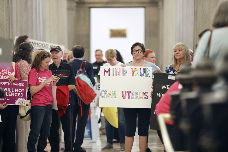 FILE - Protesters against a stricter ban on abortion in South Carolina stand in the Statehouse lobby on Tuesday, May, 23, 2023, in Columbia, South Carolina. South Carolina’s new all-male Supreme Court reversed course on abortion on Wednesday, Aug. 23, 2023, upholding a ban on most such procedures after about six weeks of pregnancy. (AP Photo/Jeffrey Collins, File)