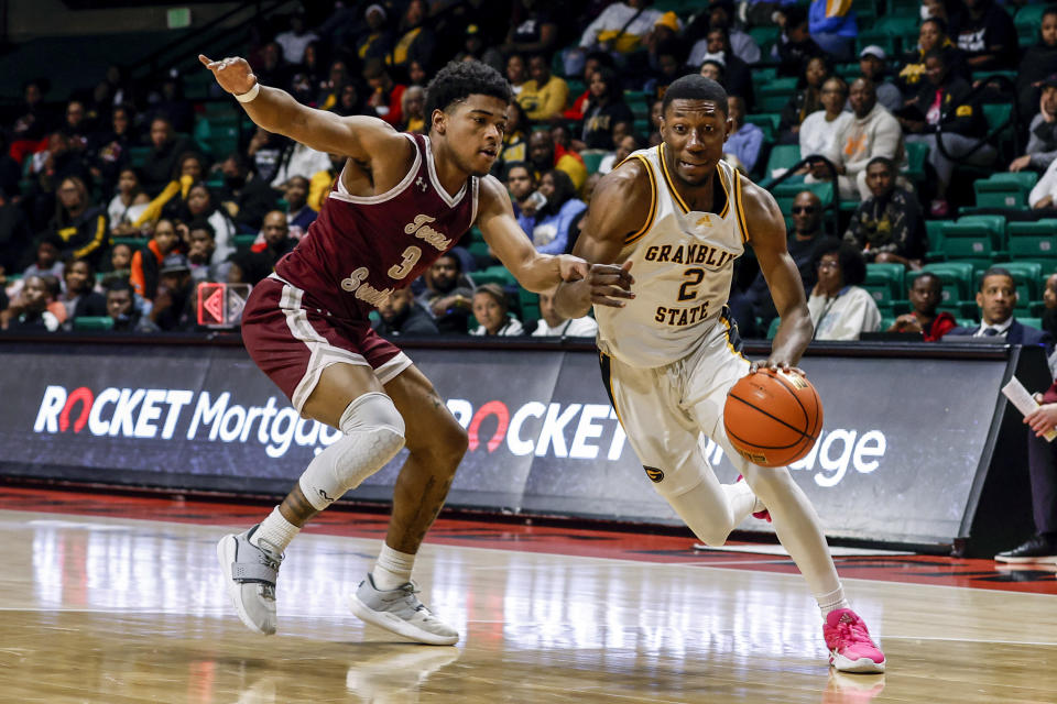 Grambling State guard Zahad Munford (2) drives to the basket around Texas Southern guard PJ Henry (3) during the first half of an NCAA college basketball game in the championship of the Southwestern Athletic Conference Tournament, Saturday, March 11, 2023, in Birmingham, Ala. (AP Photo/Butch Dill)