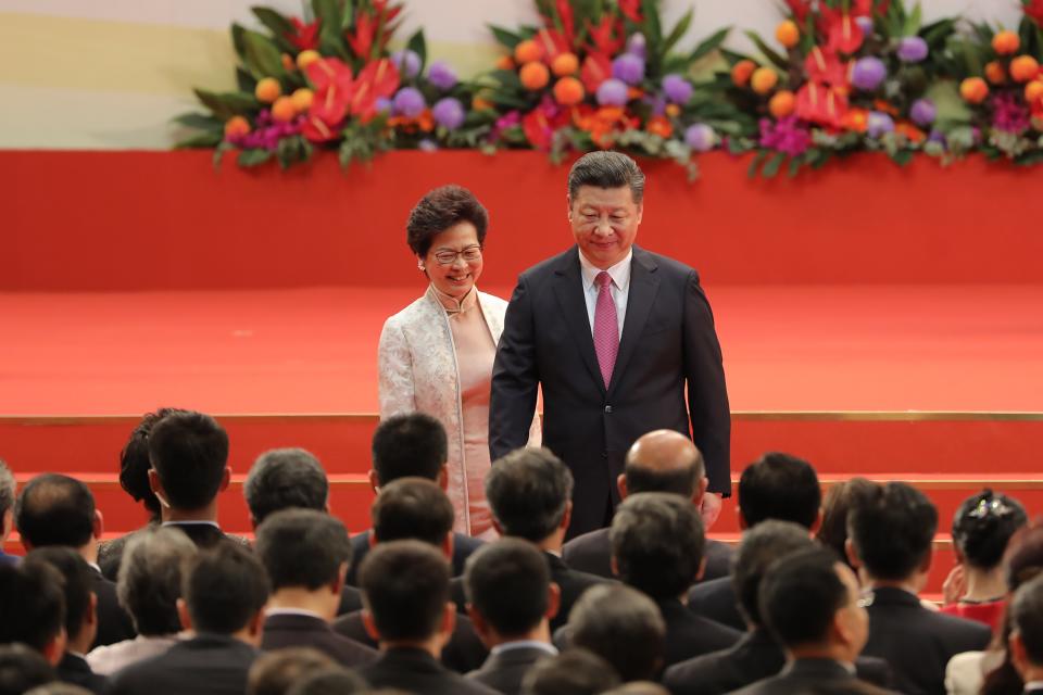 Xi Jinping, China's president, right, and Carrie Lam, Hong Kong's incoming chief executive, leave the stage during a swearing-in ceremony in Hong Kong, China, on Saturday, July 1, 2017.