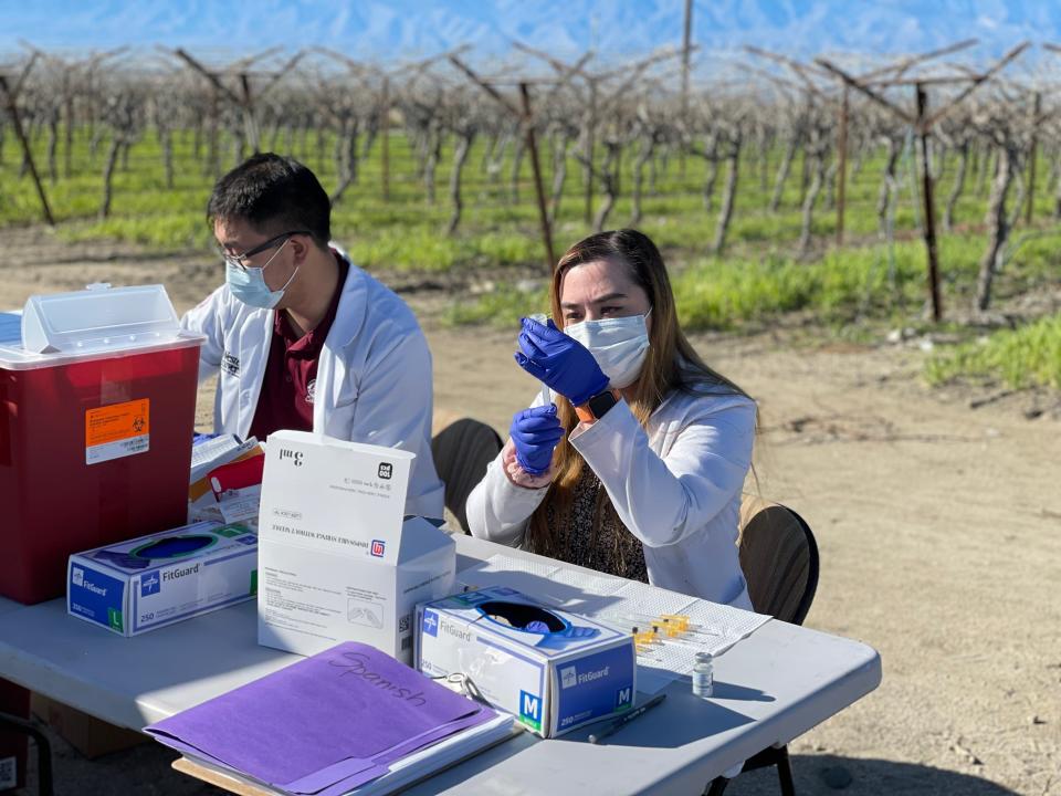 Angela Mercado, a fourth year pharmacy resident at Western University, prepares a vaccine during a Desert Healthcare District vaccination clinic in Mecca on Thursday, Jan. 19, 2023.