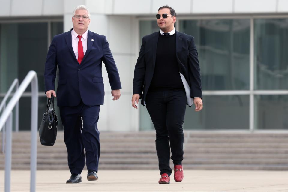 Rep. George Santos, R-N.Y., walks out of a federal courthouse in Long Island with his lawyer Joe Murray on Oct. 27, 2023 in Central Islip, N.Y.. Santos pleaded not guilty to several new fraud charges in the indictment brought against him.