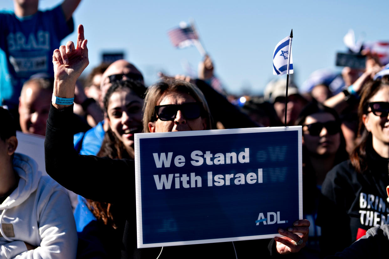 People hold pro-Israel signs and Israeli flags at the Washington rally.