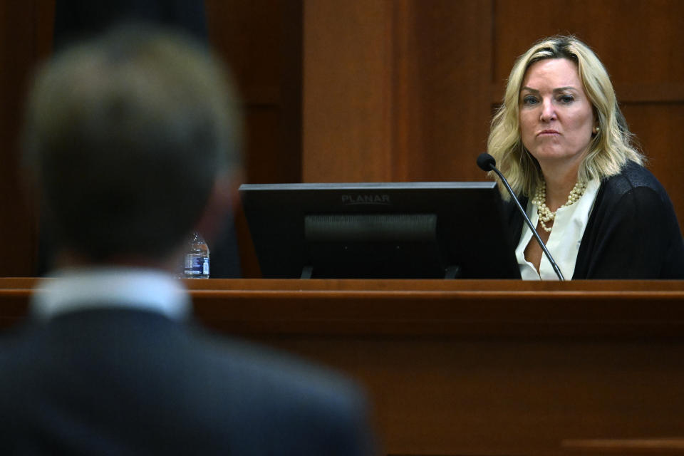 Forensic psychologist Dr. Dawn Hughes testifies as the first defense witness for actress Amber Heard at the Fairfax County Circuit Court in Fairfax, Va., Tuesday May 3, 2022. Actor Johnny Depp sued his ex-wife Amber Heard for libel in Fairfax County Circuit Court after she wrote an op-ed piece in The Washington Post in 2018 referring to herself as a "public figure representing domestic abuse." (Jim Watson/Pool photo via AP)