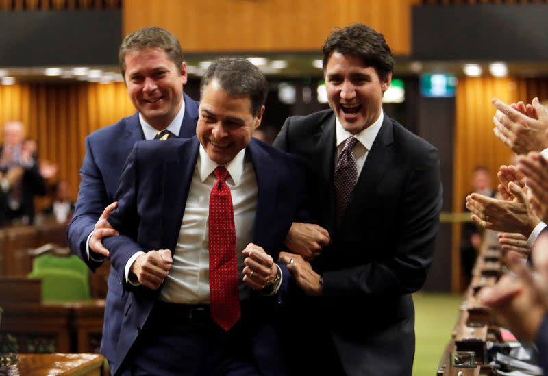 Liberal Ontario MP Anthony Rota is dragged to the Speakers chair by Canada's Prime Minister Justin Trudeau, and Conservative Party leader and Leader of the Official Opposition Andrew Scheer in Ottawa