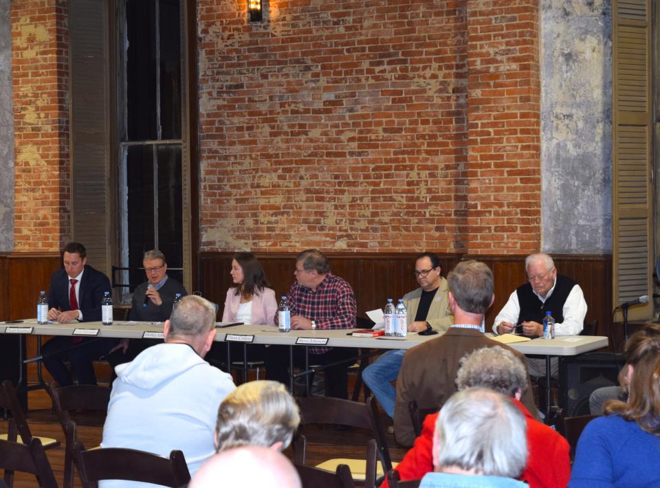 The other candidates look on as Eric Strouse (second from left) fields a question during a meet the candidate night Wednesday at American Hall in Millersburg.