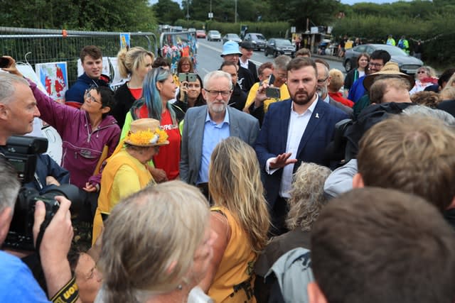 Jeremy Corbyn speaks to anti-fracking protesters outside the gate at the Preston New Road shale gas exploration site in Lancashire