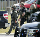 <p>Police officers in tactical gear move through the scene at Santa Fe High School after a shooting on Friday, May 18, 2018, in Santa Fe, Texas. (Photo: Kevin M. Cox/The Galveston County Daily News via AP) </p>