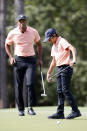 Charlie Woods reacts to missing a putt as his father Tiger Woods watches on the first green during the first round of the PNC Championship golf tournament Saturday, Dec. 18, 2021, in Orlando, Fla. (AP Photo/Scott Audette)