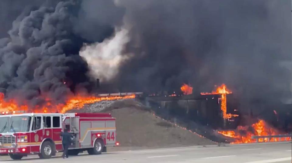 Indianapolis firefighters respond after a tanker truck carrying jet fuel overturned and burst into flames at the interchange connecting Interstates 465 and 70 on the city's east side Feb. 20, 2020. The crash killed the driver and did extensive damage to the highway.