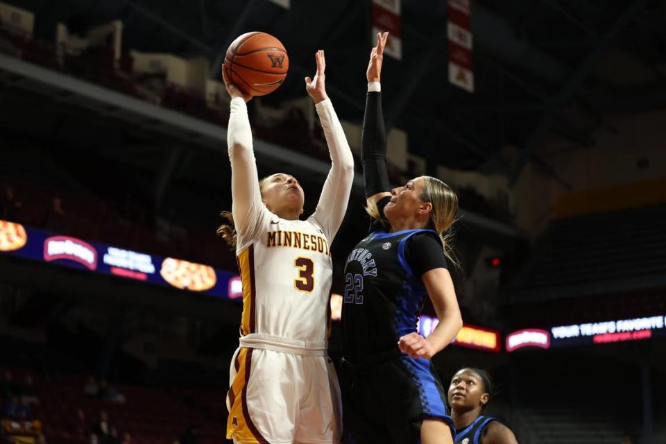 Kentucky’s Maddie Scherr challenges a shot by Minnesota’s Amaya Battle during Wednesday night’s game in Minneapolis. Scherr contributed six points, five rebounds, five assists, two blocks and five steals in UK’s win.