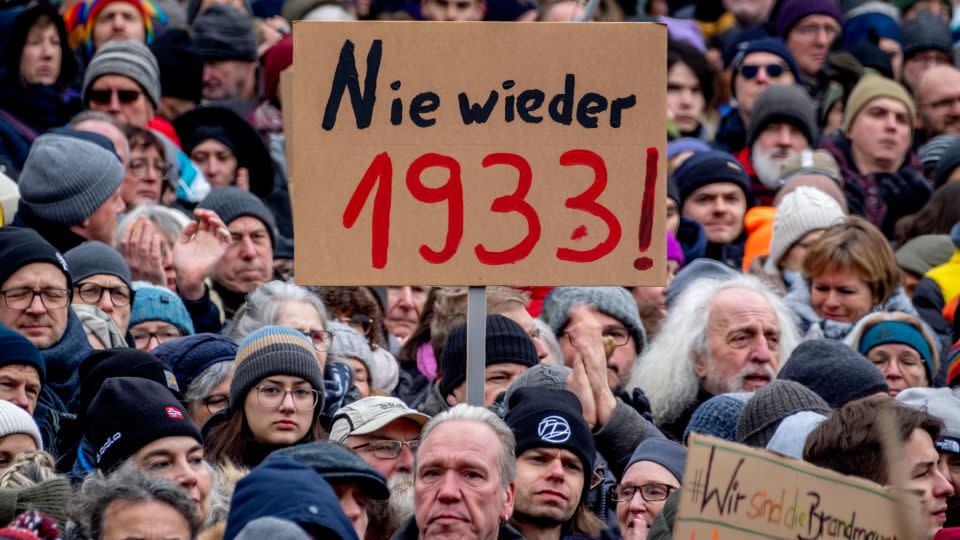 People protest in Frankfurt on Saturday, holding a banner reading "Never again 1933!" - Michael Probst/AP