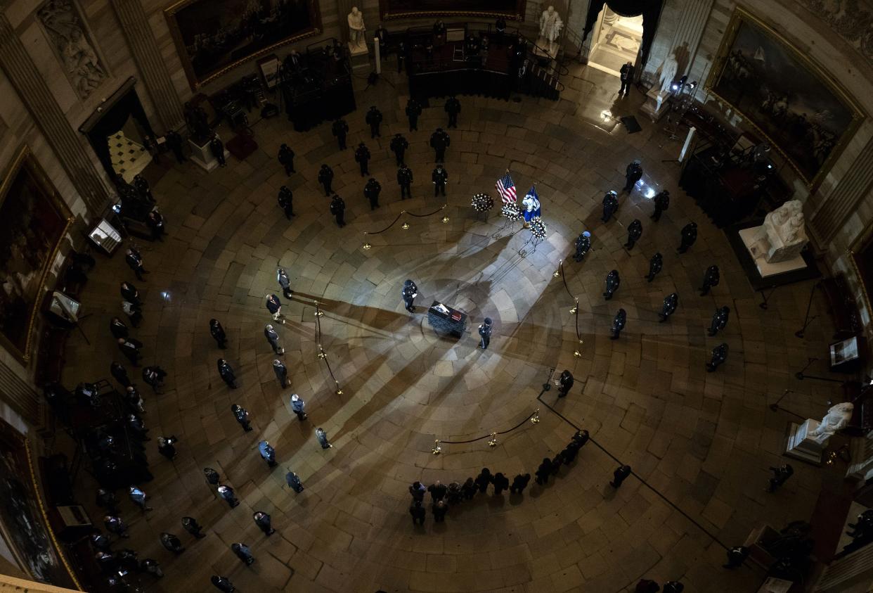 An honor guard stands at attention as an urn with the cremated remains of U.S. Capitol Police officer Brian Sicknick lies in honor in the  Capitol Rotunda Tuesday, Feb. 2, 2021, in Washington.