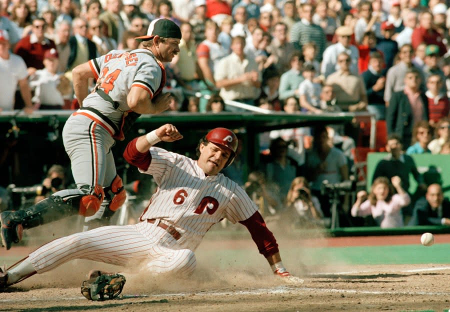 Philadelphia Phillies’ Bo Diaz slides home with Baltimore Orioles’ catcher Rick Dempsey running behind him during Game 4 of the World Series against the Philadelphia Phillies, Oct. 15, 1983, at Veterans Stadium in Philadelphia. (AP Photo)