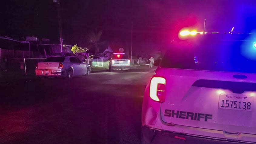 Police outside of a home in Goshen, California.