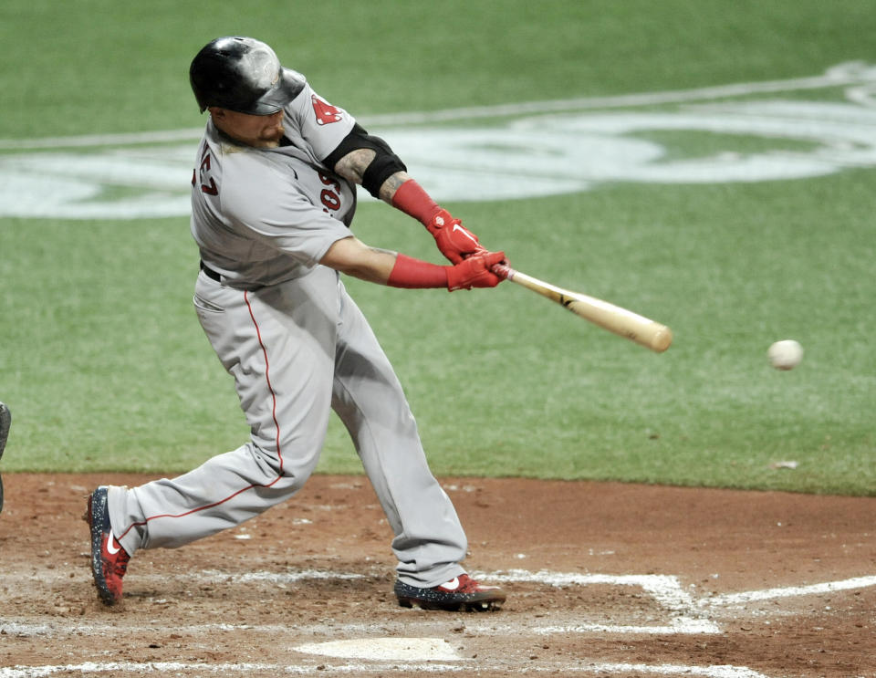 Boston Red Sox's Christian Vazquez hits a RBI-single off Tampa Bay Rays starter Ryan Yarbrough during the sixth inning of a baseball game Wednesday, Aug. 5, 2020, in St. Petersburg, Fla. (AP Photo/Steve Nesius)