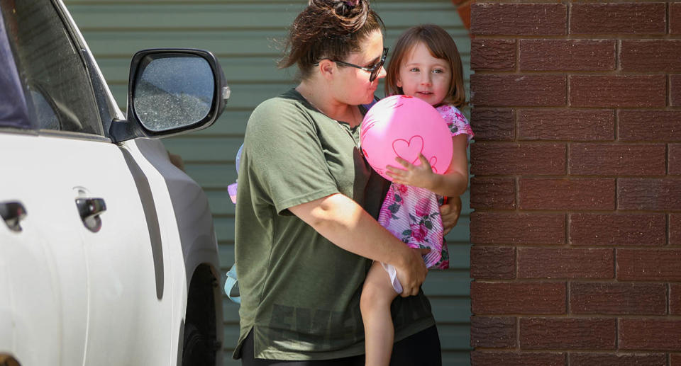 Cleo Smith is carried inside a friend's house by her mother Ellie on November 4, 2021.