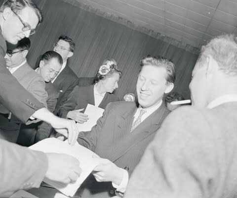 Leonid Zamyatin hands out a statement to reporters at the United Nations, circa 1956 - Credit: Bettmann