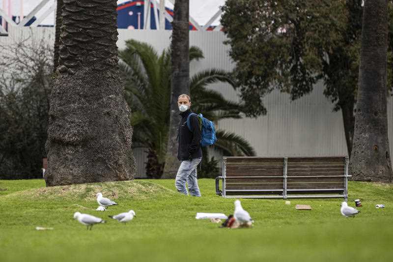 A man is seen walking through the O’Donnell gardens in St Kilda, Melbourne.