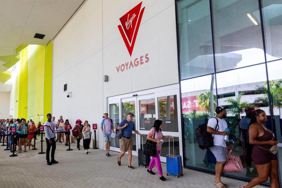 Guests wait to board the Virgin Voyages cruise ship at Port of Miami Terminal V, which Miami-Dade built for the cruise line.