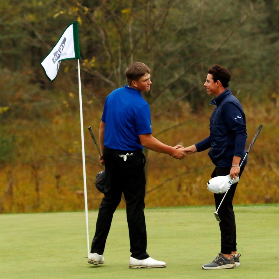 Maysville sophomore Hoyt Dodson shakes hands with Ottawa Hills' Yale Feinger following their round on Saturday at the Division II state tournament at NorthStar Golf Club in Sunbury, Ohio. Dodson shot a two-day total of 144 to place tied for 11th among 72 players, as Maysville was fifth of 12 teams.