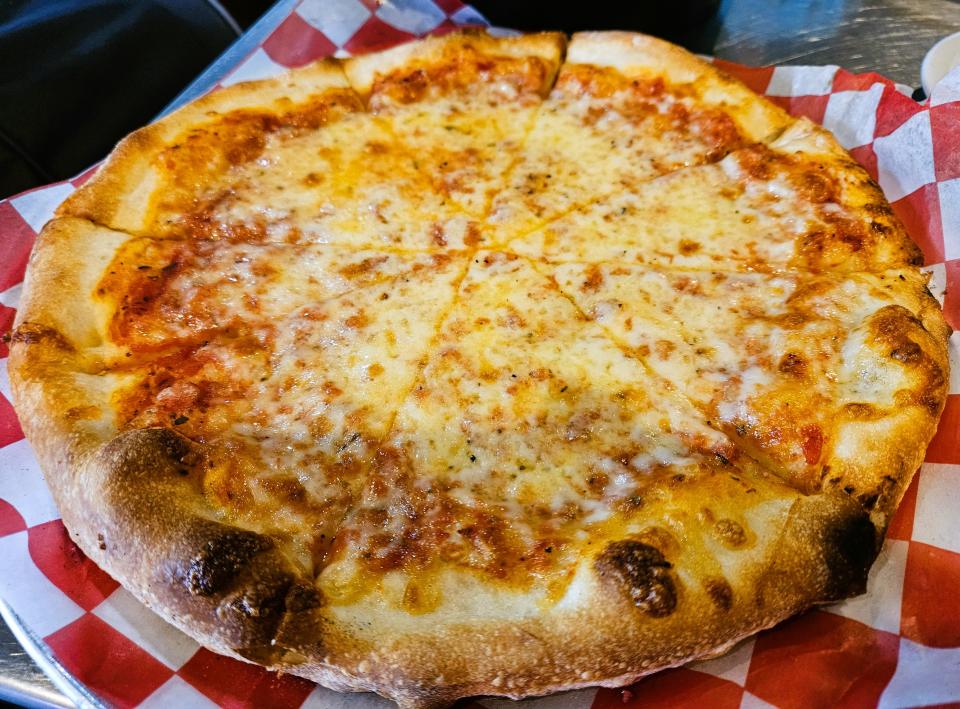 A hand-tossed “bar pie” cheese pizza at Wolves Head Pizza & Wings in Lakewood Ranch photographed Sept. 7, 2023.