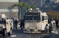 A member of security forces fires his weapon during clashes with demonstrators following a rally against the government of Venezuela's President Nicolas Maduro and to commemorate May Day in Caracas, Venezuela May 1, 2019. REUTERS/Manaure Quintero