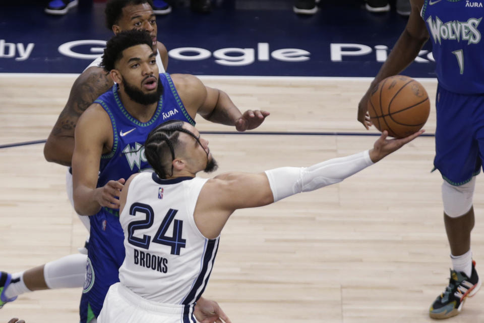 Memphis Grizzlies forward Dillon Brooks (24) shoots in front of Minnesota Timberwolves center Karl-Anthony Towns (32) during the first half in Game 6 of an NBA basketball first-round playoff series Friday, April 29, 2022, in Minneapolis. (AP Photo/Andy Clayton-King)