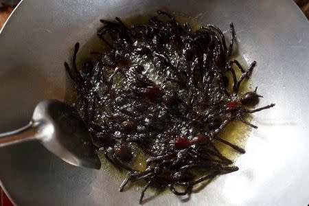 Tarantulas are fried in a pan in Kampong Cham province in Cambodia, April 19, 2017. Picture taken April 19, 2017. REUTERS/Samrang Pring