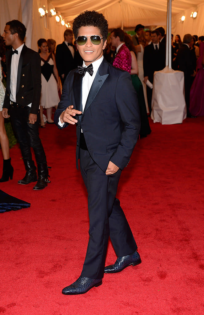  <p class="MsoNormal">Bruno Mars also hit up the fun fashion event wearing a classic tux. Though known for his pompadour, the “Just the Way You Are” singer looked as if he had moved into another era (perhaps the ‘70s?) thanks to his tinted aviator shades and naturally curly locks.</p>