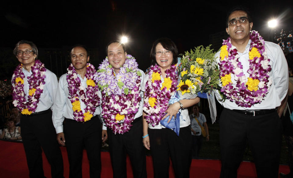 The winning opposition Workers' Party of Singapore team for Aljunied group representative constituency (GRC) poses for photos in Singapore early May 8, 2011. The team consisted of (from L-R) Chen Show Mao, Muhamad Faisal Manap, party secretary-general Low Thia Khiang, chairman Sylvia Lim and Pritam Singh.  REUTERS/Tim Chong (SINGAPORE - Tags: POLITICS ELECTIONS)