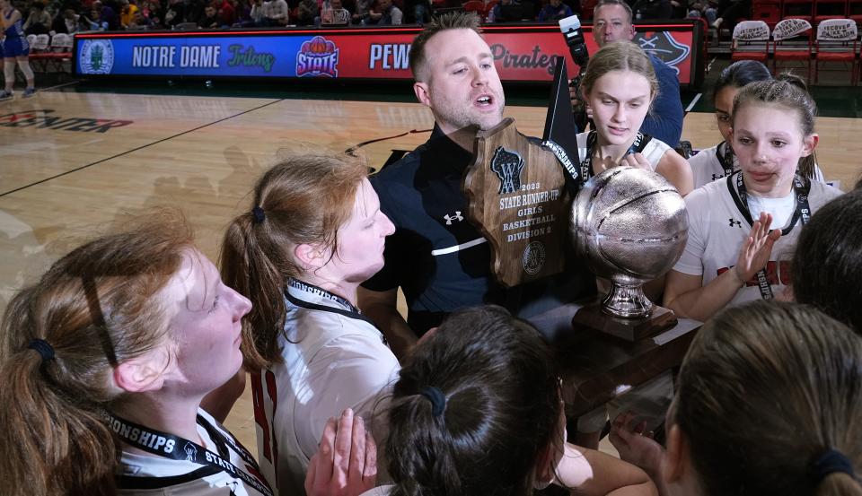 Pewaukee girls basketball coach Jim Reuter holds the runner-up trophy after the WIAA Division 2 championship game in March.
