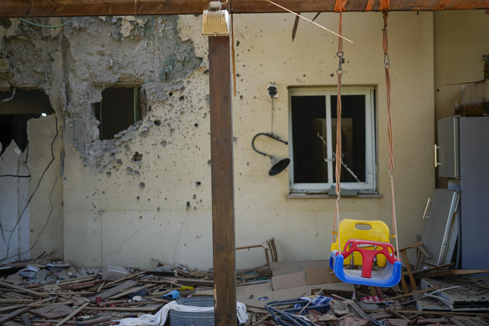 FILE - A children's swing hangs in a house damaged by Hamas militants is seen in Kibbutz Be'eri, Israel, Saturday, Oct. 14, 2023. The kibbutz was overrun by Hamas militants from the nearby Gaza Strip on Oct. 7, when they killed and captured many Israelis. (AP Photo/Ariel Schalit)