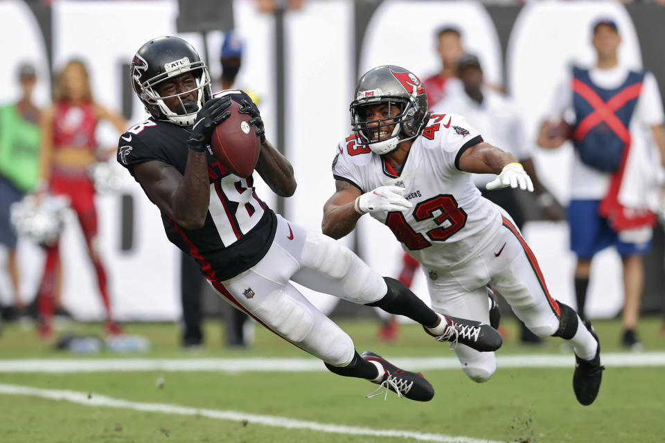 FILE - Atlanta Falcons wide receiver Calvin Ridley (18) makes a diving touchdown reception in front of Tampa Bay Buccaneers defensive back Ross Cockrell (43) during the second half of an NFL football game in Tampa, Fla., in this Sunday, Sept. 19, 2021, file photo. Matt Ryan is looking to see the Atlanta Falcons' offense continue its improvement when the team returns from its bye week for Sunday's game in Miami. Having top target Calvin Ridley back in the lineup should help the offense. Ryan said Wednesday, Oct. 20, 2021, Ridley “was flying around” in his return to practice after missing the Falcons' last game for personal reasons. (AP Photo/Mark LoMoglio, File)