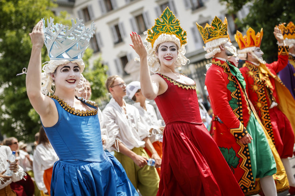 People take part of the "Fete des Vignerons" (winegrowers' festival in French), parade during the official opening parade prior to the first representation and crowning ceremony in Vevey, Switzerland, Thursday, July 18, 2019. Organized in Vevey by the brotherhood of winegrowers since 1979, the event will celebrate winemaking from July 18 to August 11 this year. (Valentin Flauraud/Keystone via AP)