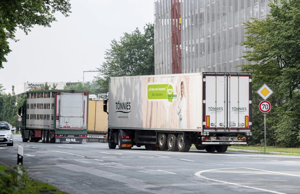 Image: Trucks leave the Toennies meatpacking plant in Rheda-Wiedenbrueck, Germany, (David Inderlied / AP)