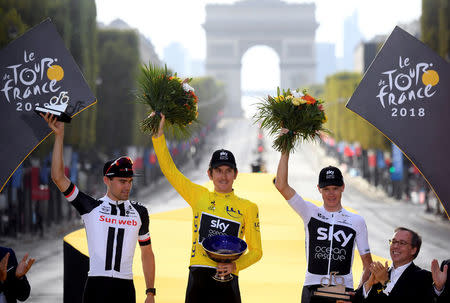 FILE PHOTO: Cycling - Tour de France - The 116-km Stage 21 from Houilles to Paris Champs-Elysees - July 29, 2018 - Team Sky rider Geraint Thomas of Britain, wearing the overall leader's yellow jersey, Team Sunweb rider Tom Dumoulin of the Netherlands and Team Sky rider Chris Froome of Britain celebrate on the podium. Stephane Mantey/Pool via REUTERS/File Photo