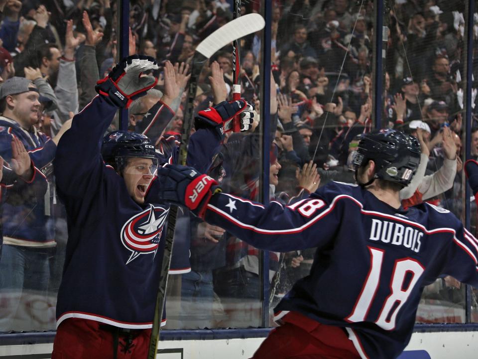 Columbus Blue Jackets left wing Artemi Panarin (9) celebrates with Columbus Blue Jackets center Pierre-Luc Dubois (18) after scoring on Washington Capitals goaltender Braden Holtby (70) during the 3rd period in Game 3 of the Stanley Cup Playoffs first-round series at Nationwide Arena in Columbus, Ohio on April 17, 2018.  [Kyle Robertson/Dispatch] 