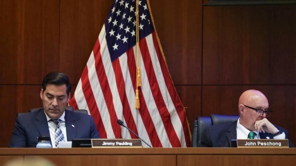 Supervisors Jimmy Paulding and John Peschong study a presentation at the San Luis Obispo County Board of Supervisors meeting on May 21, 2024.