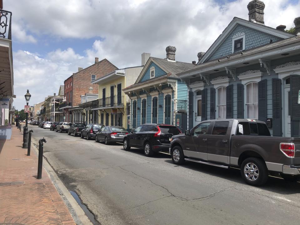 This Wednesday, May 20, 2020 photo, shows a row of houses just off Bourbon Street in New Orleans’ French Quarter. The closure of night clubs and bars on Bourbon and other parts of the quarter during the coronavirus pandemic has brought at least a temporary end to tensions between some entertainment venues and some residents who say the balance between the interests of businesses and residents who own or rent homes in the historic district has been upset by a growing number of tourists. (AP Photo/Kevin McGill)