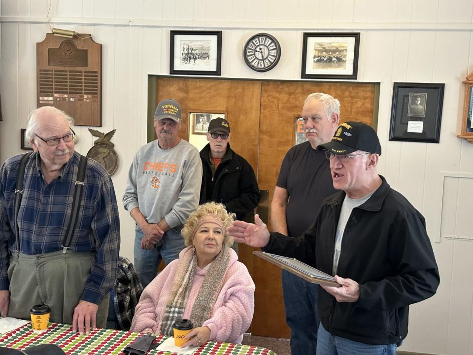 Members of the Cheboygan County Veterans Subcommittee present Michigan National Guard veteran Gary Voisin (left) with the Hometown Hero for the month award.