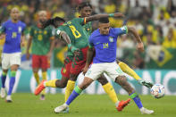 Brazil's Gabriel Jesus, right, and Cameroon's Andre-Frank Zambo Anguissa, left, fight for the ball during the World Cup group G soccer match between Cameroon and Brazil, at the Lusail Stadium in Lusail, Qatar, Friday, Dec. 2, 2022. (AP Photo/Moises Castillo)