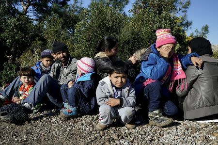 Syrian refugees wait on a roadside near a beach in the western Turkish coastal town of Dikili, Turkey, after Turkish Gendarmes prevented them from sailing off for the Greek island of Lesbos by dinghies, March 5, 2016. REUTERS/Umit Bektas