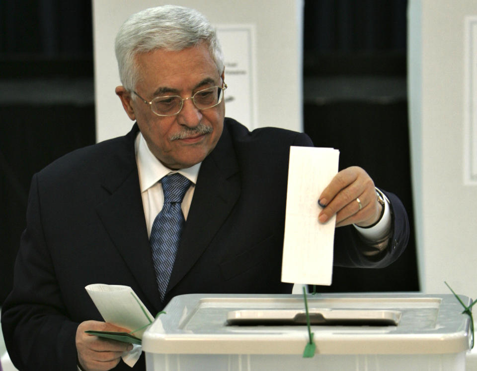 FILE - In this Jan. 25, 2006 file photo, Palestinian President Mahmoud Abbas, casts his ballot in the Palestinian Parliamentary elections at his headquarters in the West Bank town of Ramallah. When the Palestinians last held elections 15 years ago, the Islamic militant group Hamas won a landslide victory after campaigning as a scrappy resistance movement. That will be a harder sell this time around. Top Hamas officials have decamped to luxury hotels in Turkey and Qatar, leaving ordinary Palestinians to suffer the consequences of their policies. (AP Photo/Muhammed Muheisen, File)